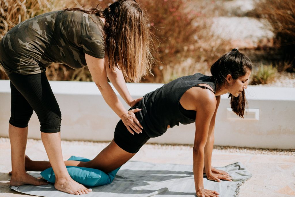 personal trainer assisting an athlete